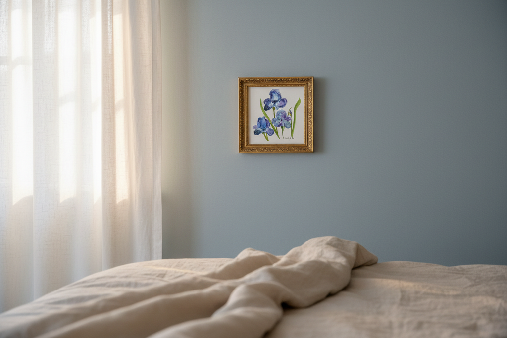 Blue Irises watercolor painting shown framed in a bedroom