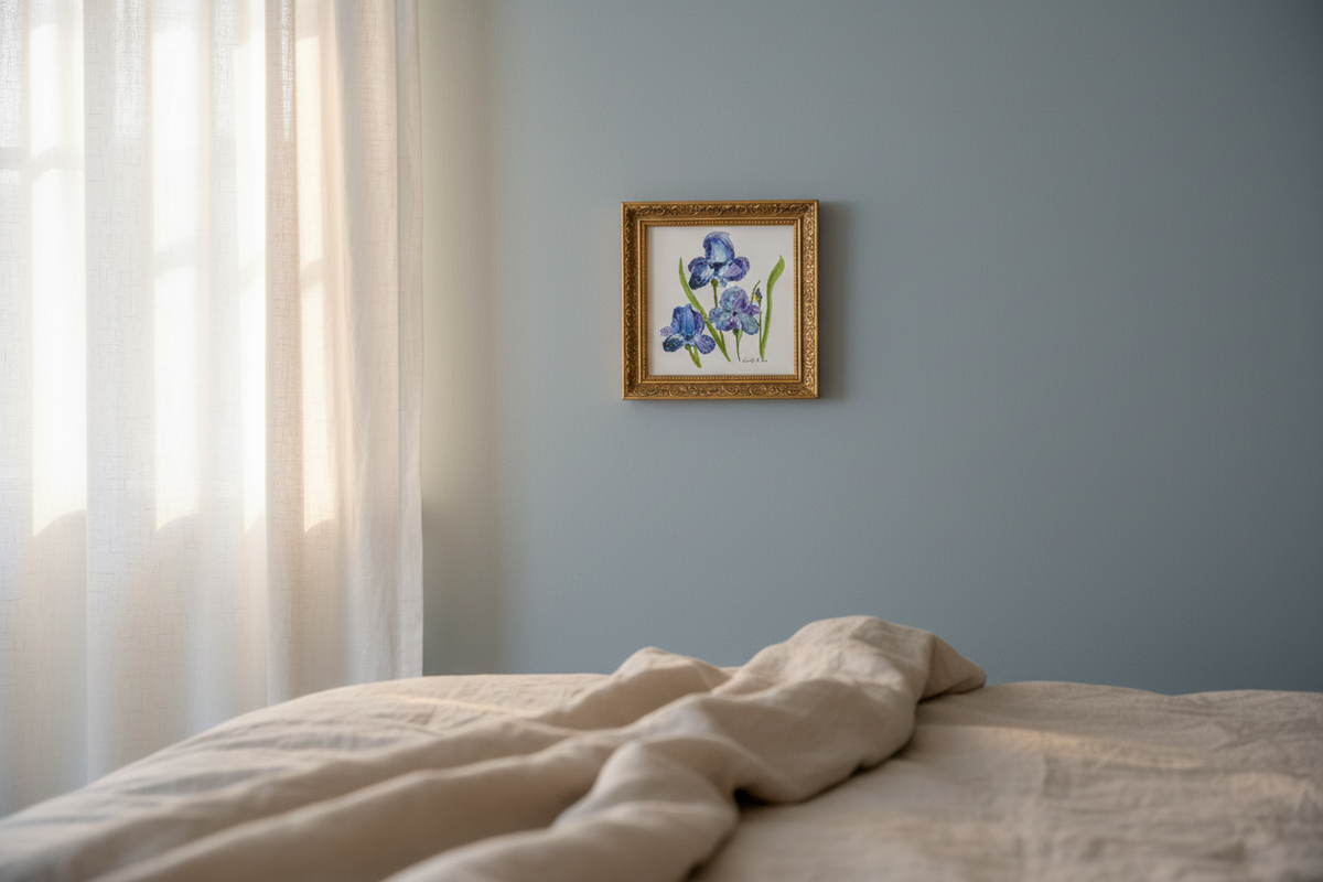 Blue Irises watercolor painting shown framed in a bedroom
